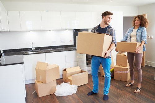 Professional movers handling household furniture